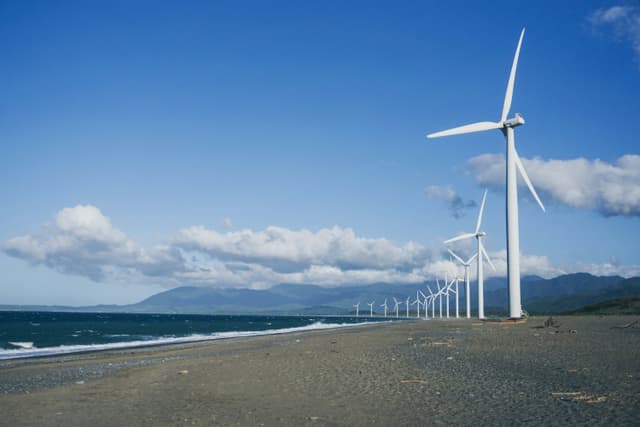 img1-https://unsplash.com/photos/wind-turbines-on-gray-sand-near-body-of-water-during-daytime-TxsU_3V7di4